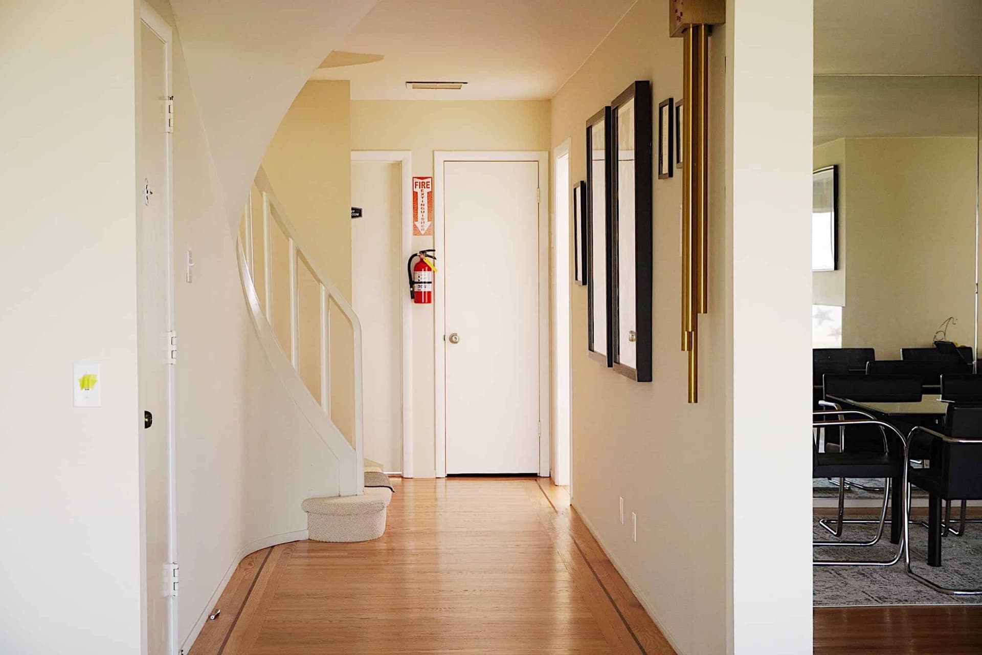 Main hallway with hardwood floors and a curved staircase